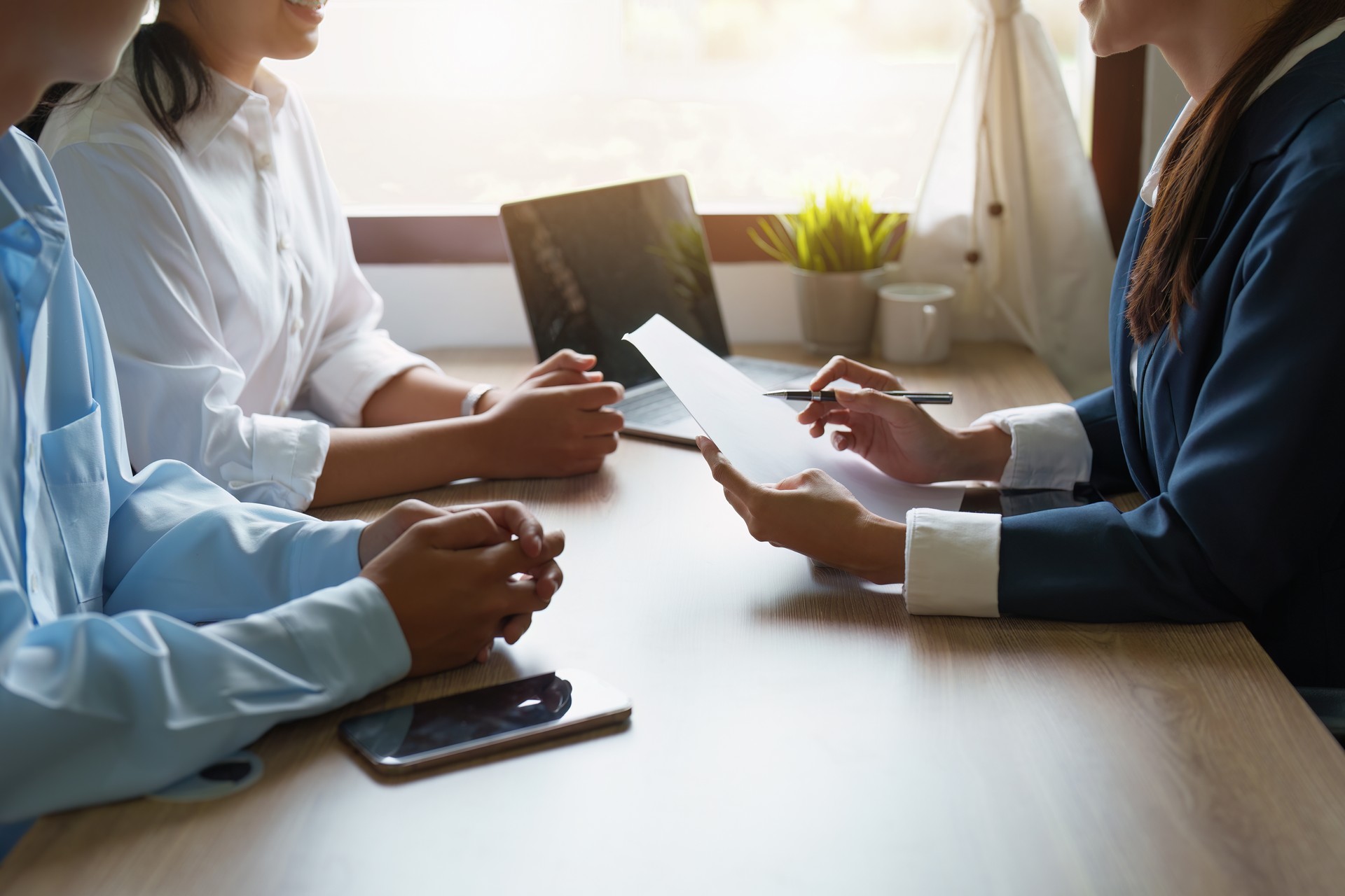 Couples consult with a representative to plan an insurance contract